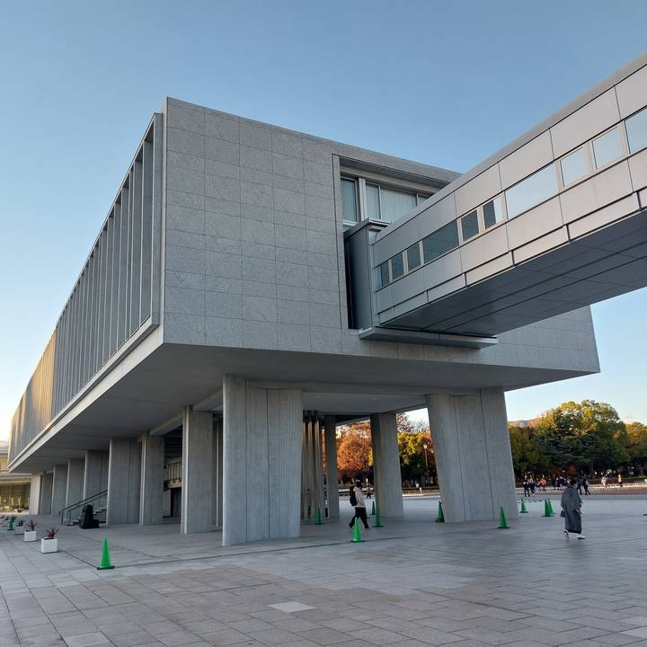 Large modern structure with people nearby.