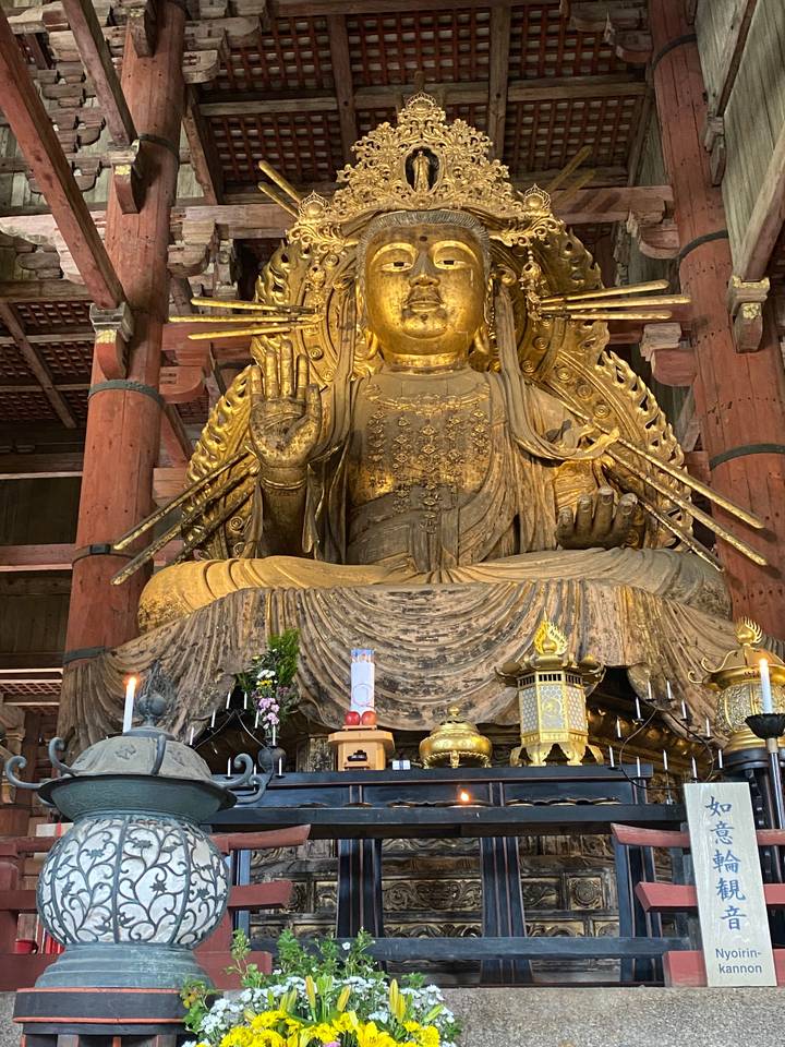 Golden statue of a deity inside a temple.