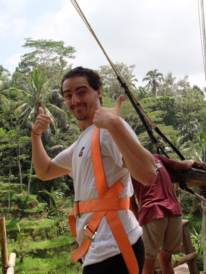 Person making a thumbs-up near a swing.
