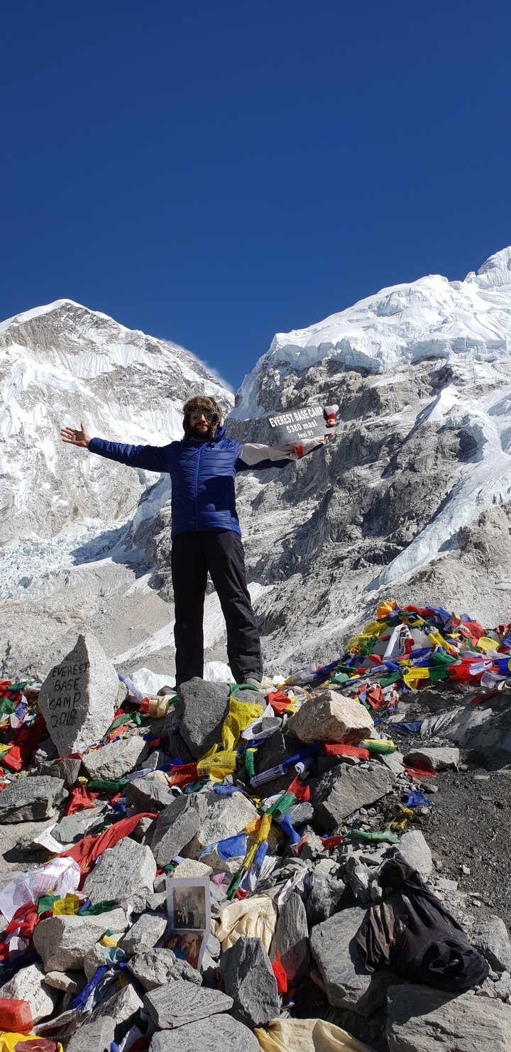 Person holding a sign, with a mountain background.