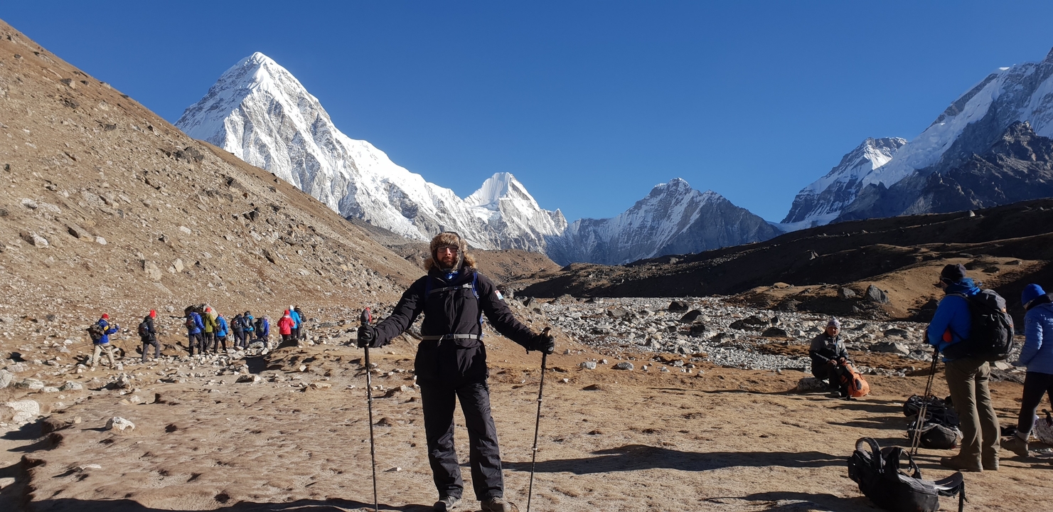 Person with hiking gear in a mountainous area.
