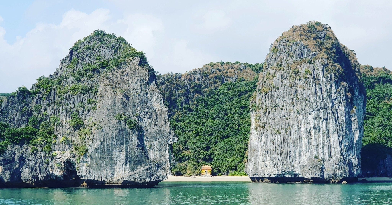Tall limestone karsts rising from the sea.