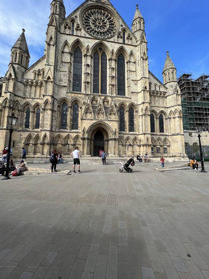 A large cathedral with intricate architecture under a blue sky.
