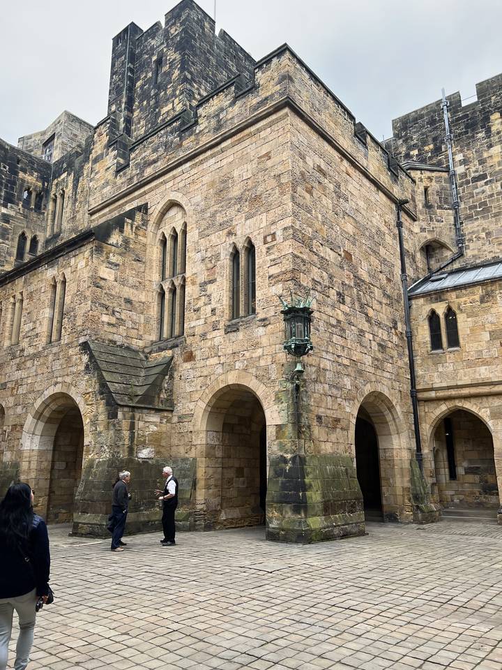 A historic stone building with a cobblestone path.