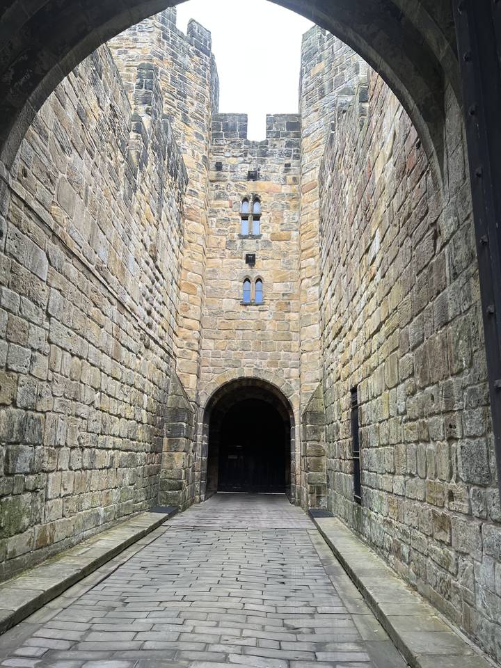 A stone gate with wooden doors.