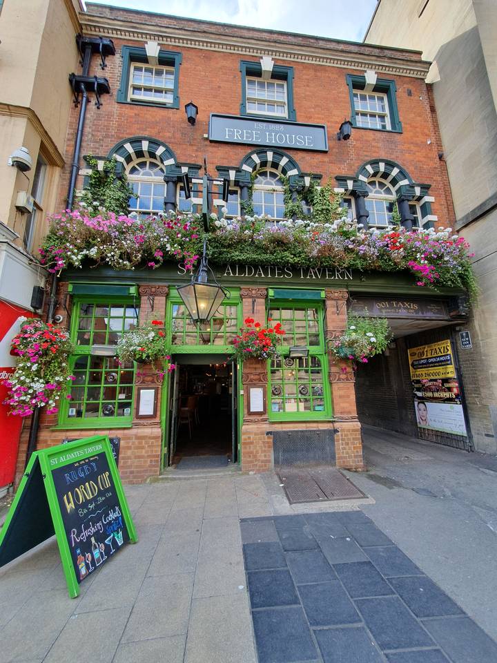 Historic tavern with floral decorations on the facade.