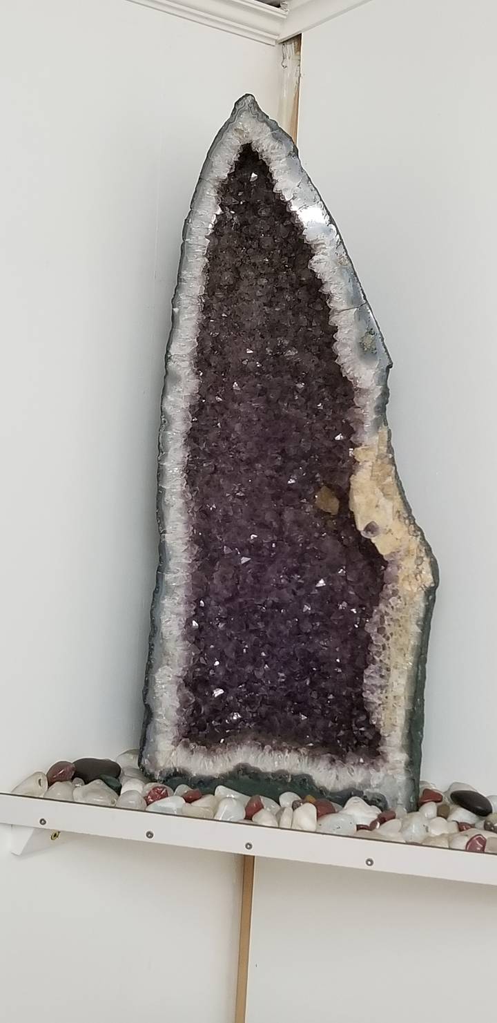 Amethyst geode displayed on a wall.