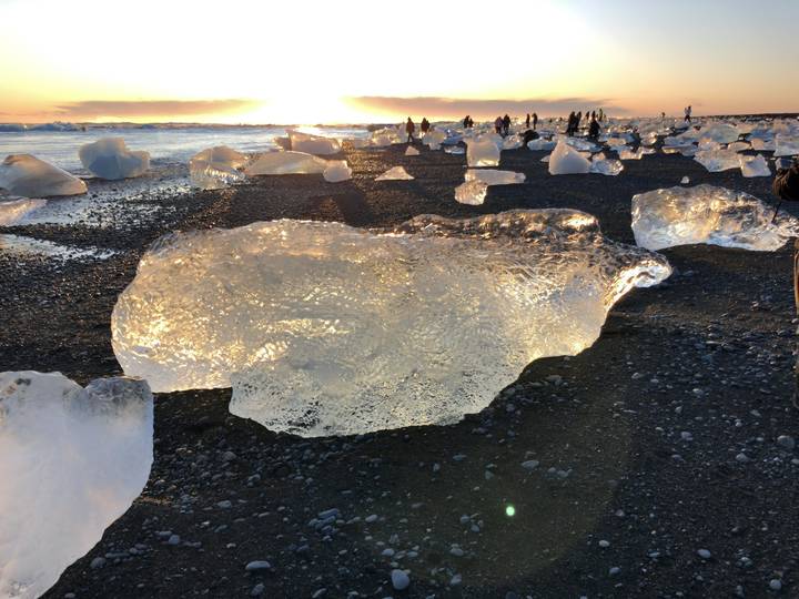 Large ice chunks on a black sand beach.