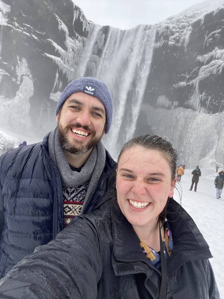 Couple taking a selfie in front of a frozen waterfall