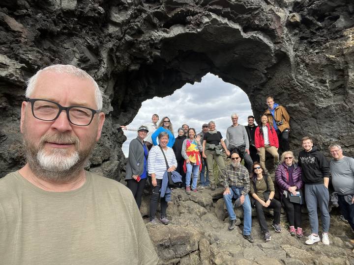 Group of people posing in a rocky area.