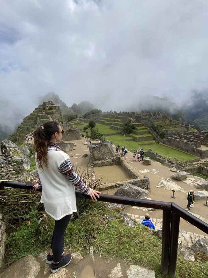 A person looking out over the terraces at Machu Picchu.