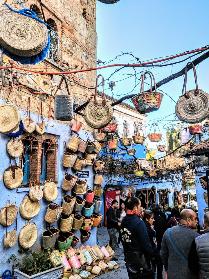 Street scene with hanging baskets and traditional buildings.