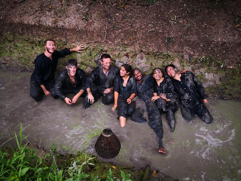 People covered in mud enjoying a playful moment.