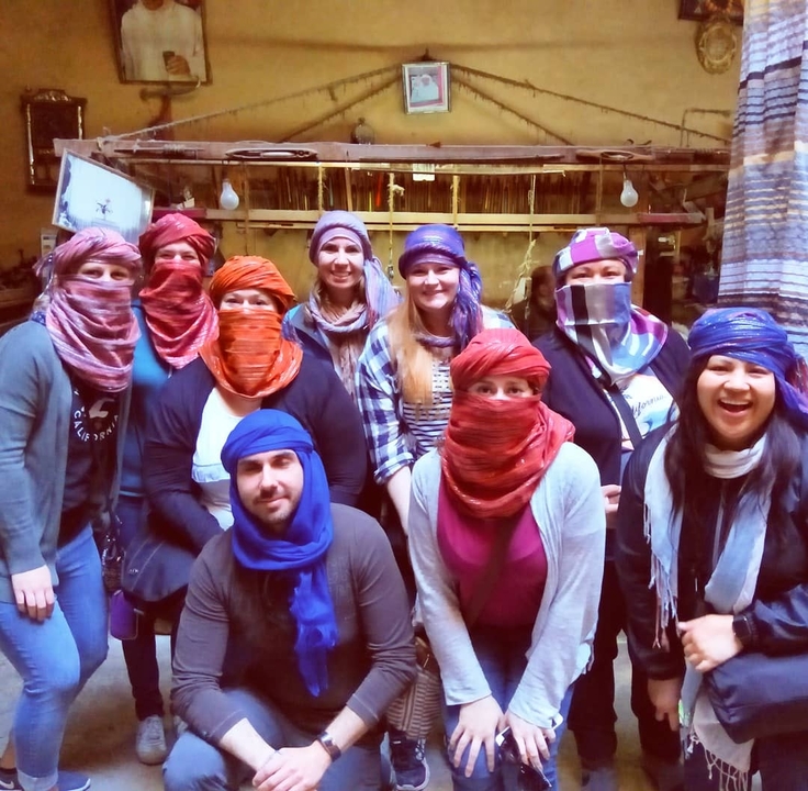 Group of people with scarves covering their faces.