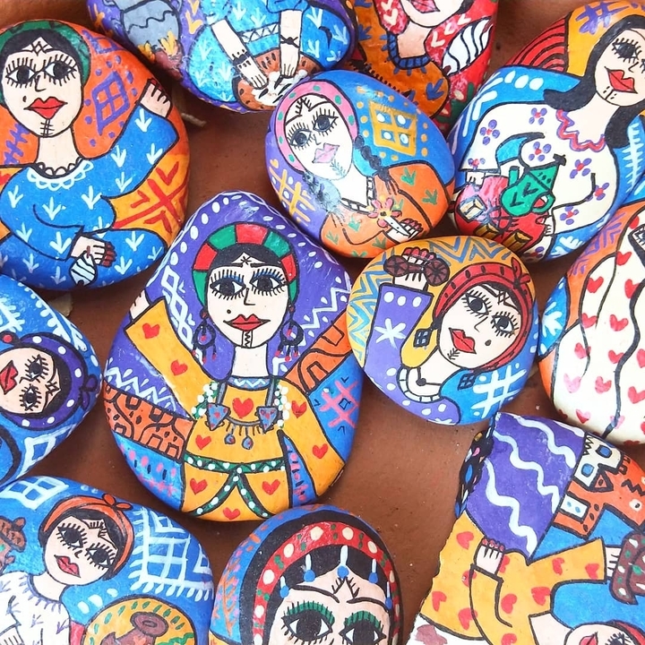 Colorful painted stones with artistic designs.