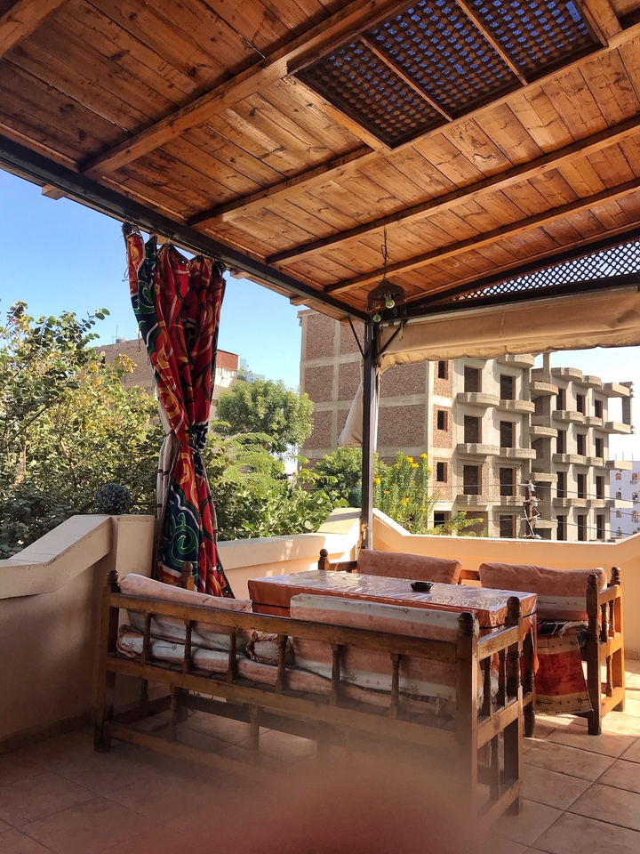 Outdoor dining area with view over a cityscape.