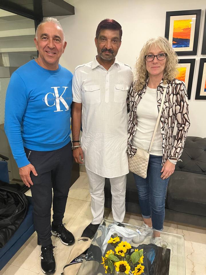 Three people standing indoors.