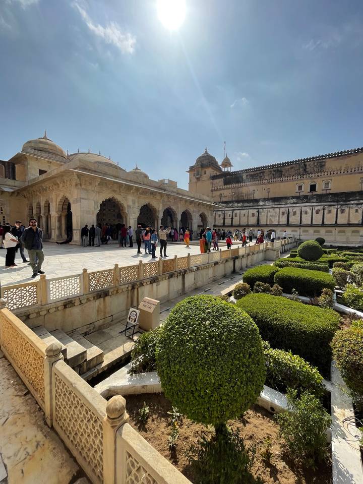 Courtyard of historical building crowded with visitors.