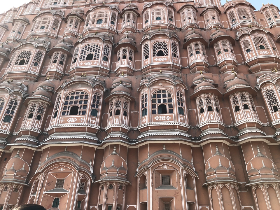 Historic pink sandstone facade with intricate windows.