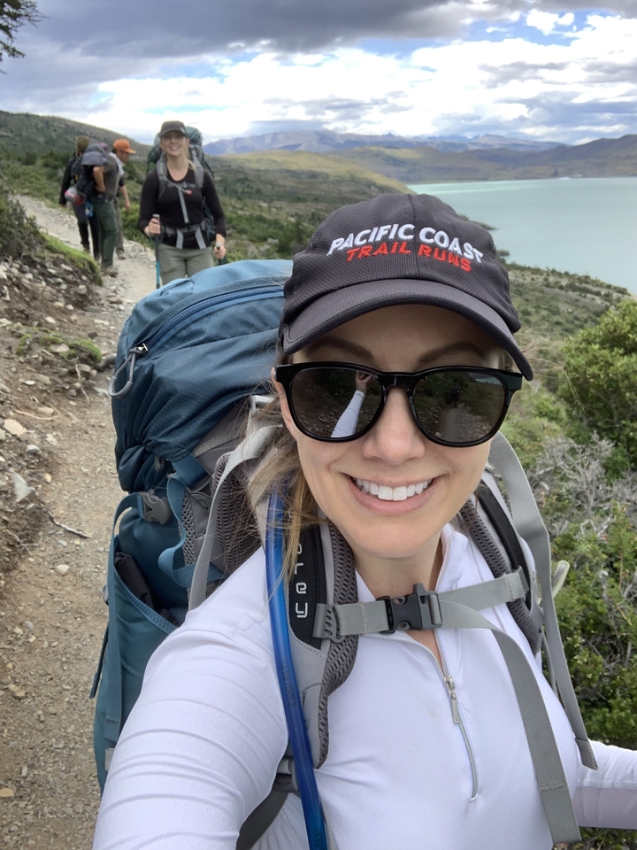 Person hiking with a backpack on a trail.