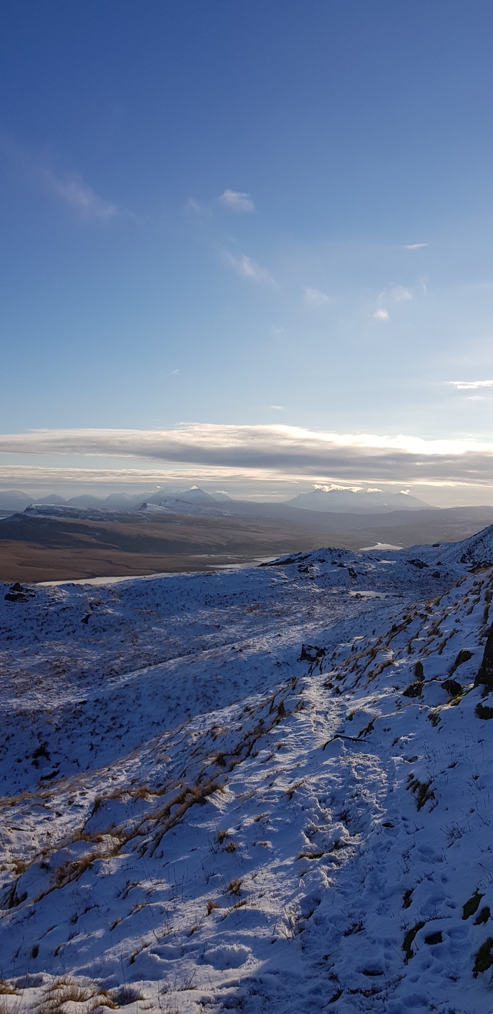 Snow-capped mountains and a distant landscape.
