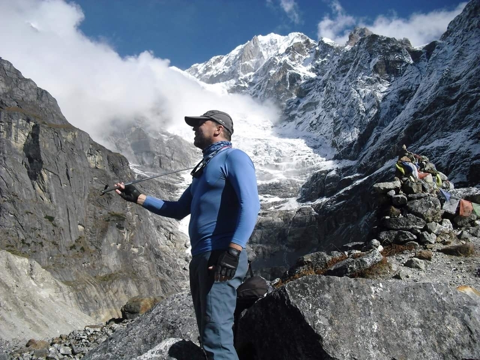 A person with a backdrop of snowy mountains, possibly near Everest.