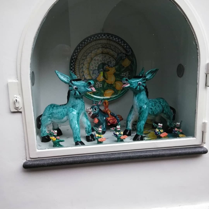 Ceramic figurines displayed on a shelf.