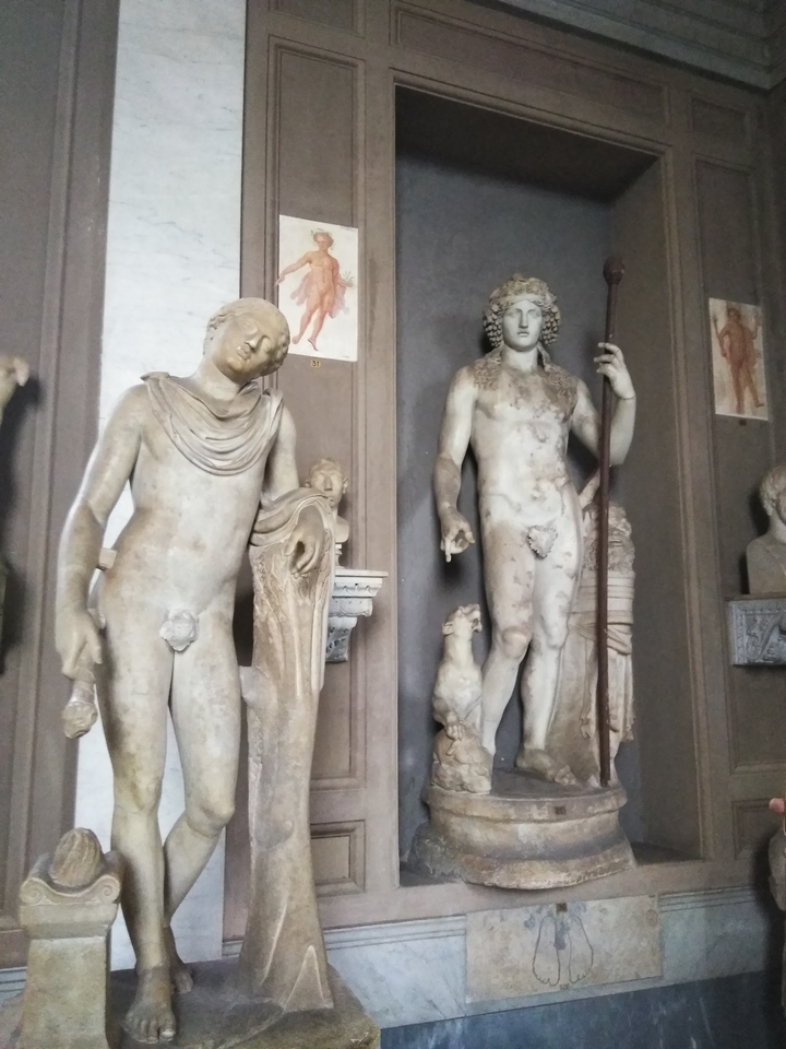 A photograph of classical statues in a museum.
