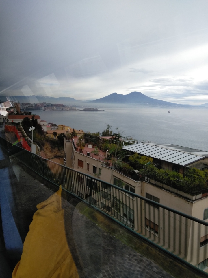 A scenic view of a coastline with mountains in the background.