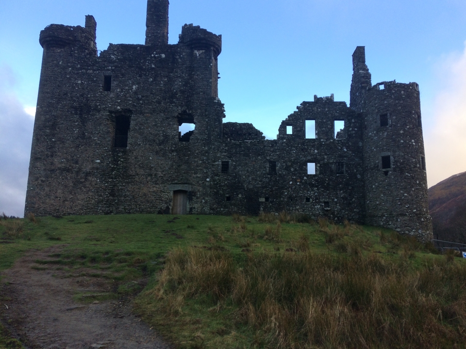 Ruined stone castle on a hill.