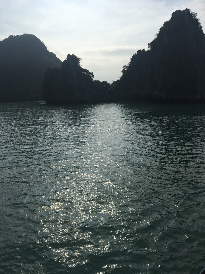 Water surface reflecting distant land and sky.