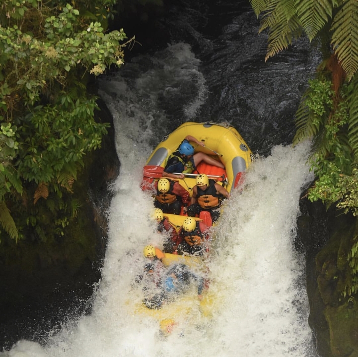 People rafting down a waterfall.