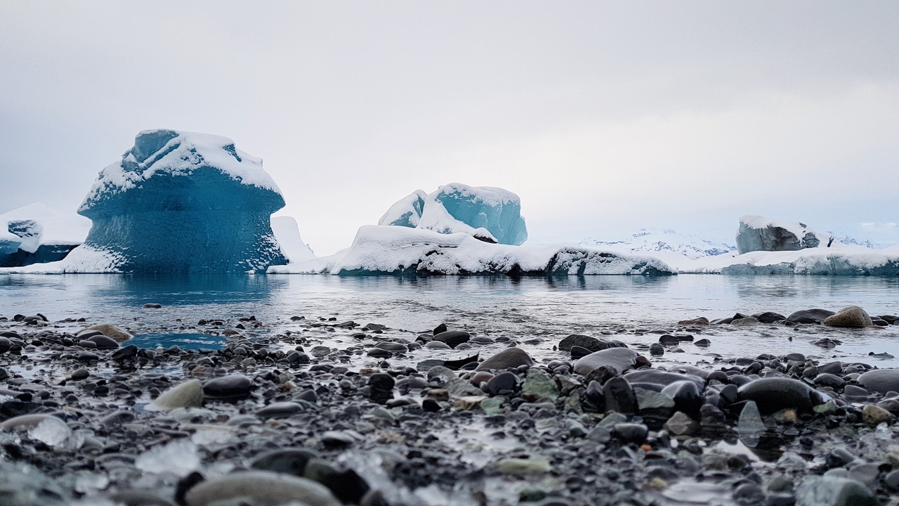 Icebergs floating in a serene lake.