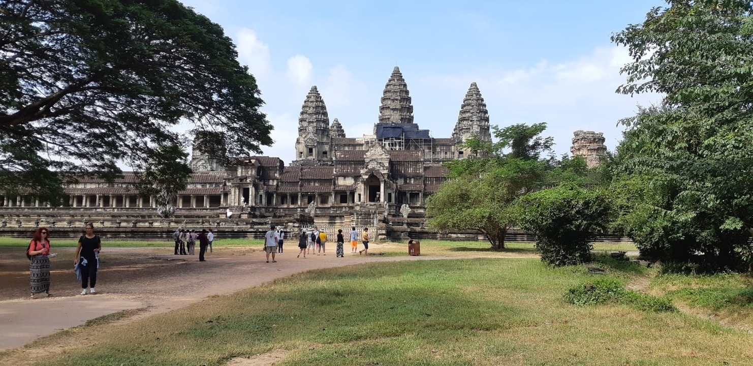 Tourists walking in front of Angkor Wat.