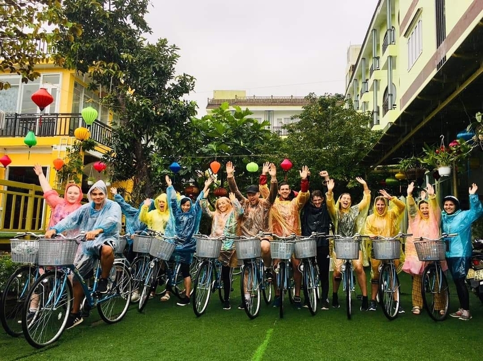 Group of people on bicycles wearing rain ponchos