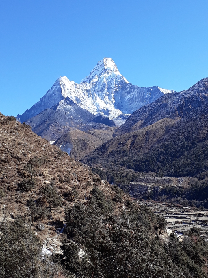 Mountainous valley landscape with snow and rocks.