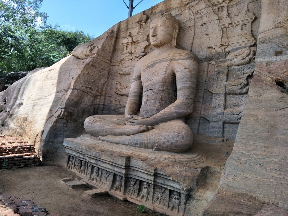 Ancient stone carving of a seated figure.