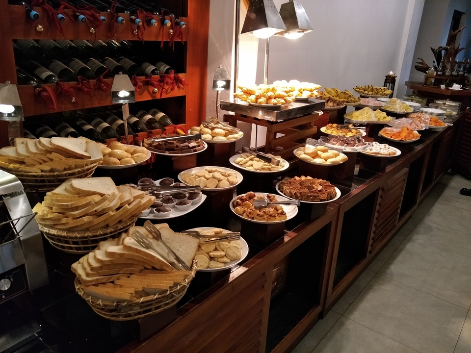 Buffet table with various pastries and snacks.