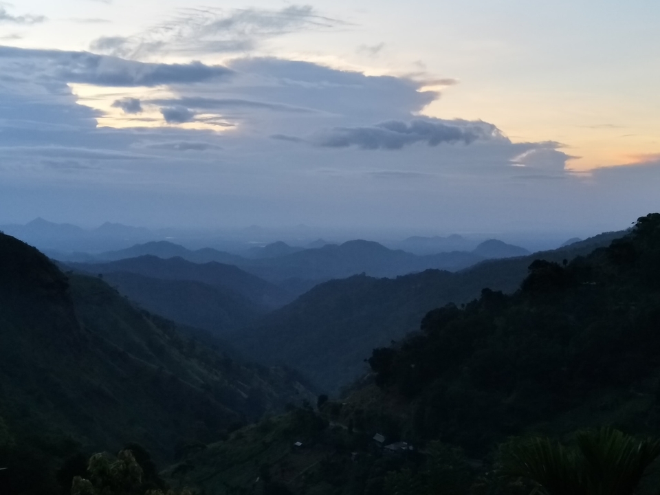 View of a mountain range at dusk with a colorful sky.