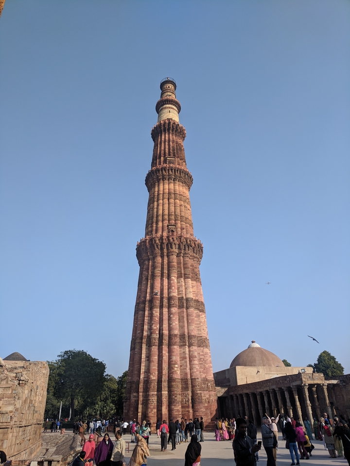 Tall minaret with a clear blue sky.