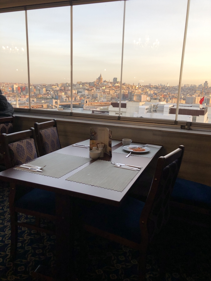 Restaurant table with a view of a cityscape.