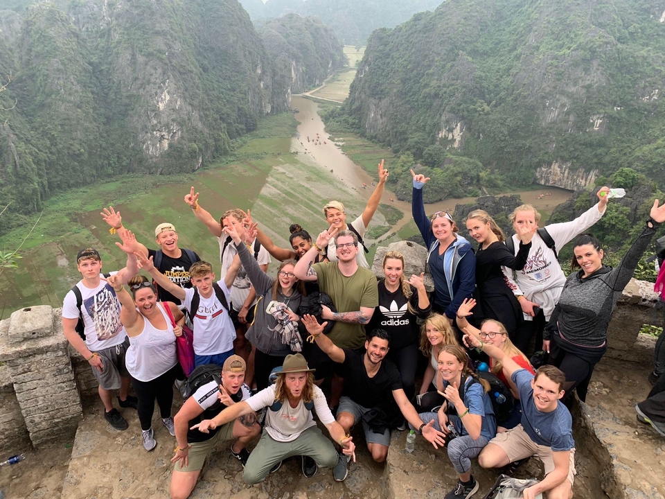Large group on a hill with scenic views in the background.