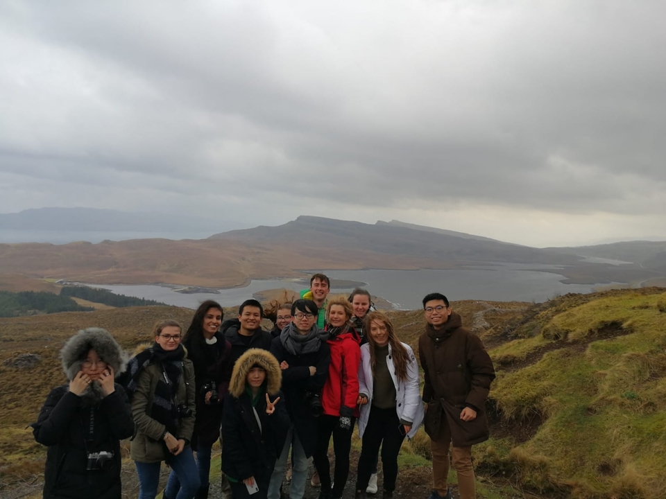 Group of travelers with mountains in the background.