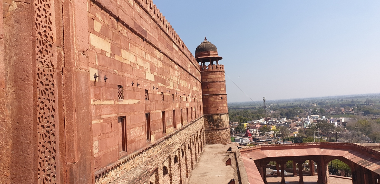 Fortification wall with detailed architecture and a scenic background.