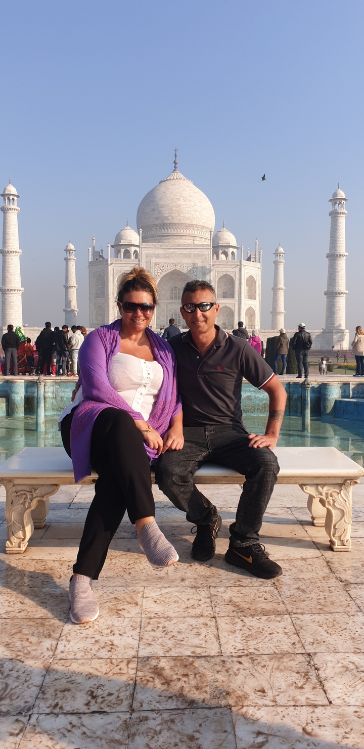 Couple posing in front of the Taj Mahal