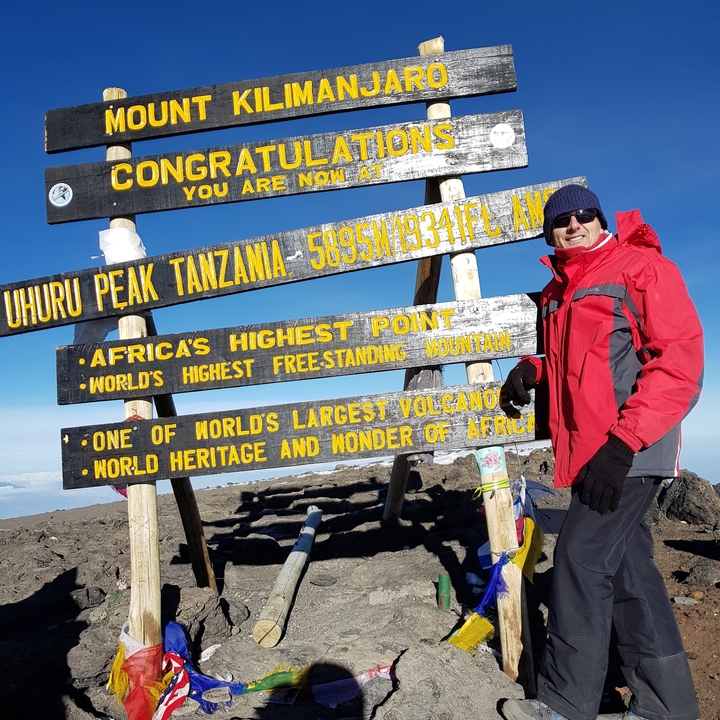 Personne au panneau du sommet Uhuru sur le mont Kilimandjaro