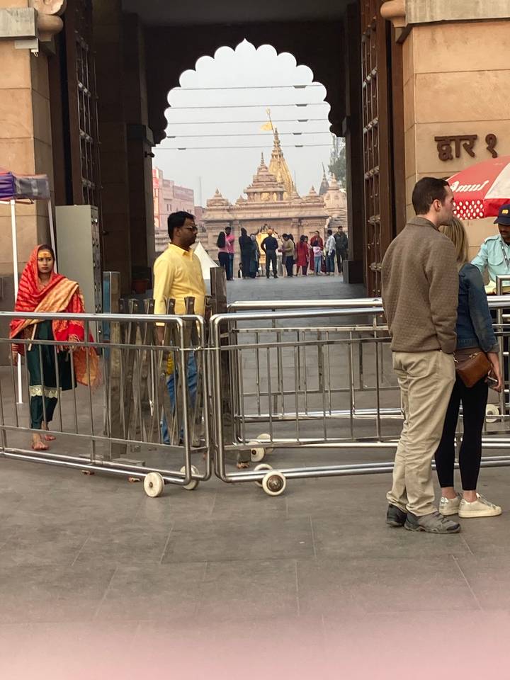 Crowded entrance of a historic site with people.