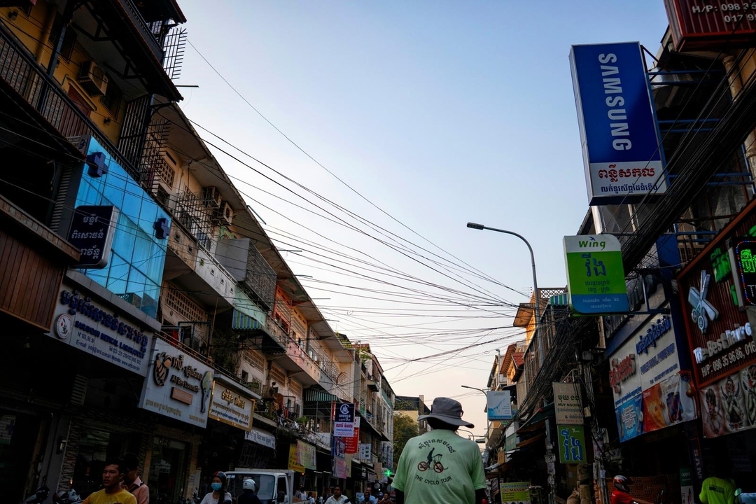 Scène de rue urbaine au Cambodge avec des panneaux.