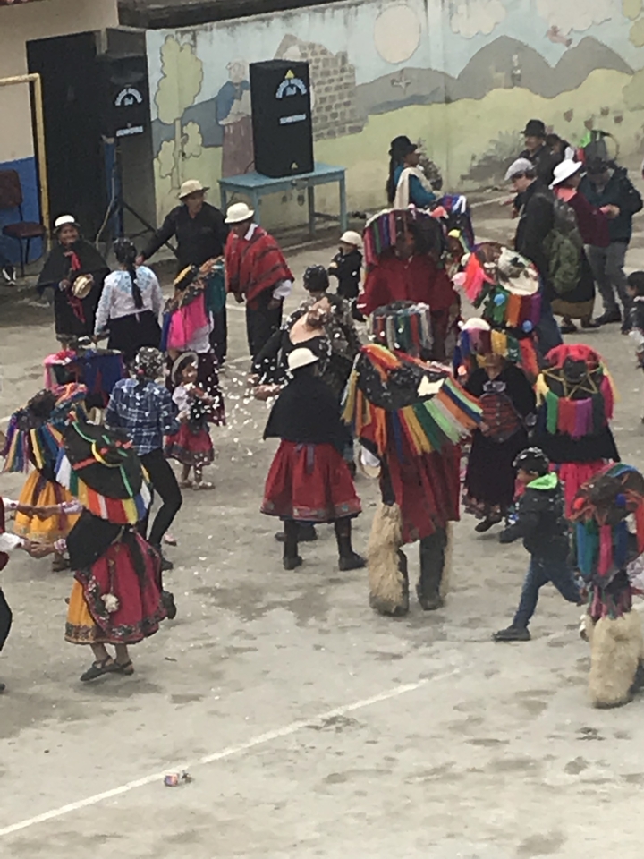 Colorful traditional dance with people in vibrant costumes.