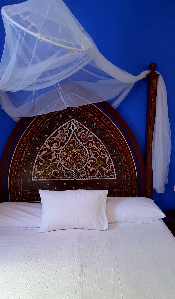 Decorative headboard with intricate patterns.